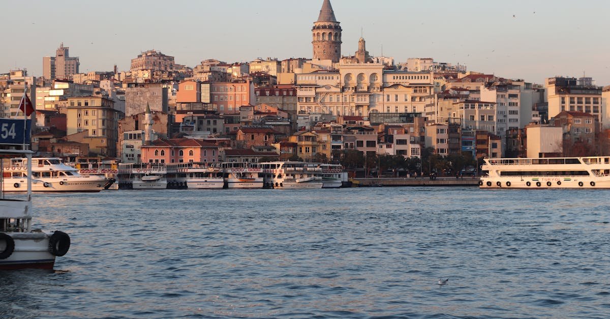 A breathtaking view of the Galata Tower and Istanbul's vibrant waterfront at sunset.